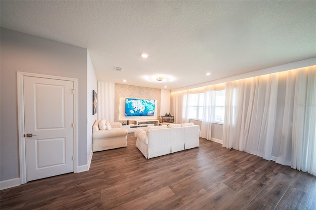 1631 Pontiff Pl, Davenport, FL 33896 - living area with dark wood-style flooring, baseboards, recessed lighting, and a textured ceiling
