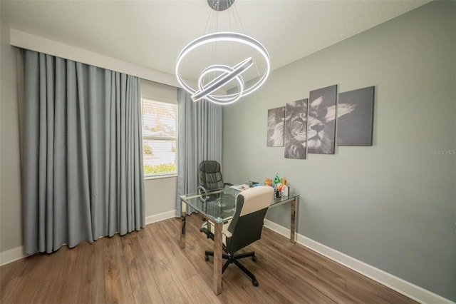 1631 Pontiff Pl, Davenport, FL 33896 - office area featuring wood finished floors, baseboards, and a chandelier