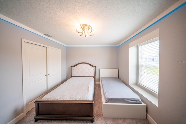 1631 Pontiff Pl, Davenport, FL 33896 - carpeted bedroom with a textured ceiling, baseboards, crown molding, and a closet