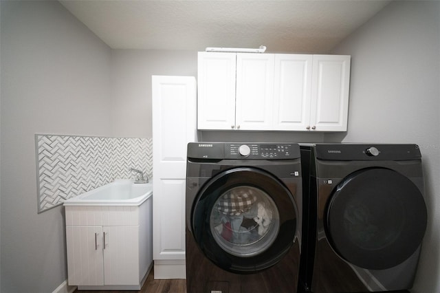 1631 Pontiff Pl, Davenport, FL 33896 - laundry room featuring washing machine and clothes dryer, cabinet space, and wood finished floors