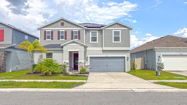 1631 Pontiff Pl, Davenport, FL 33896 - view of front of home featuring roof mounted solar panels, driveway, a garage, and board and batten siding