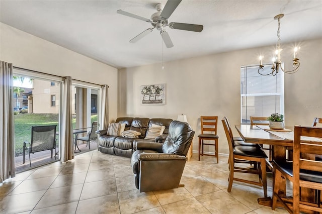 living room with light tile patterned floors and ceiling fan with notable chandelier