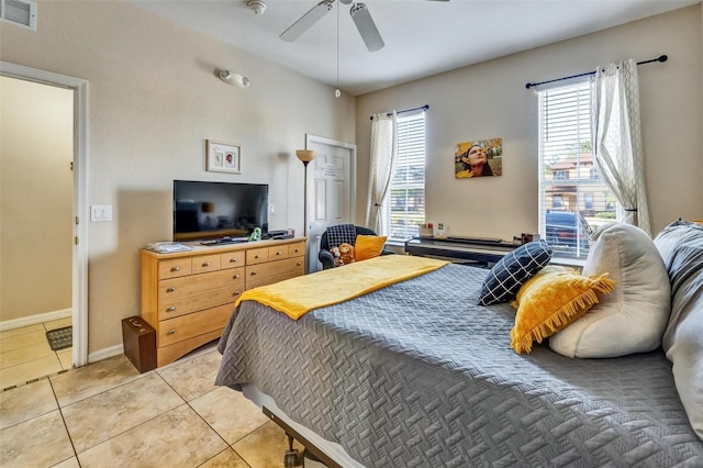 bedroom featuring ceiling fan, light tile patterned flooring, baseboards, and visible vents