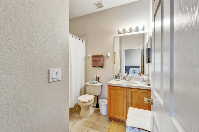 full bathroom with toilet, vanity, visible vents, tile patterned flooring, and a textured wall