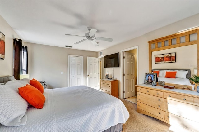 bedroom featuring light colored carpet, a closet, ceiling fan, and visible vents