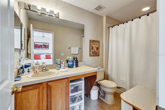 bathroom with toilet, vanity, visible vents, tile patterned floors, and connected bathroom