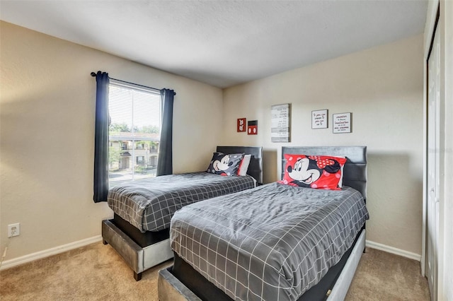 carpeted bedroom with baseboards