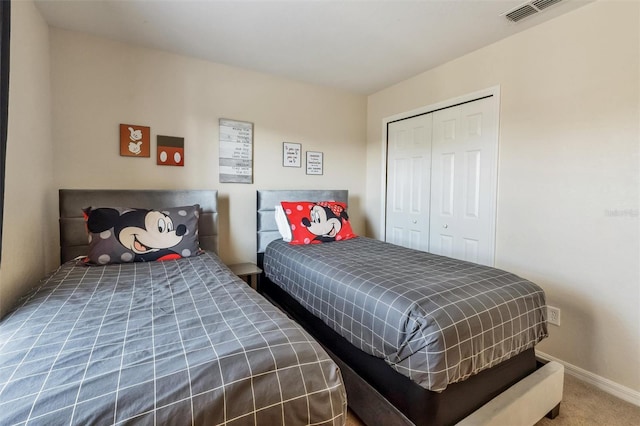 bedroom with baseboards, carpet flooring, a closet, and visible vents