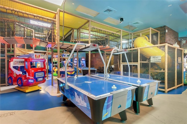 game room with visible vents and concrete floors