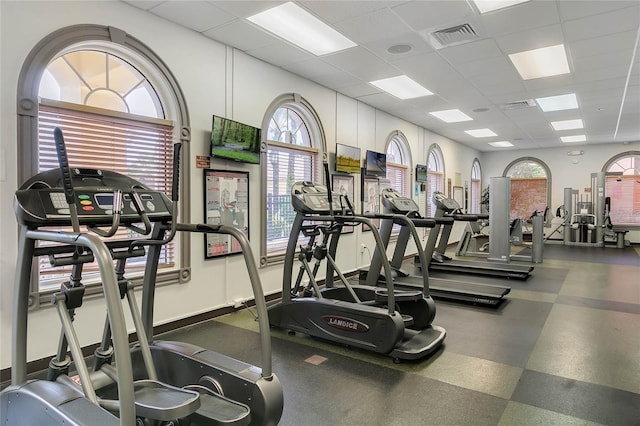 exercise room with visible vents and a drop ceiling