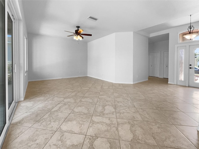 empty room featuring a ceiling fan and baseboards
