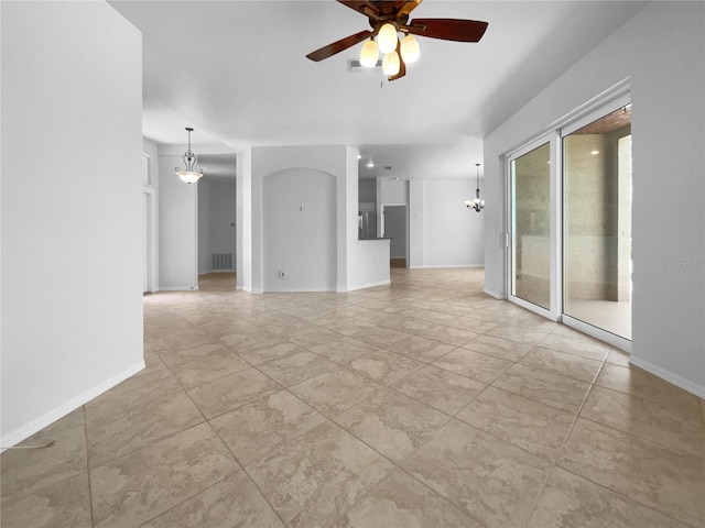 spare room with ceiling fan, a chandelier, baseboards, and light tile patterned floors