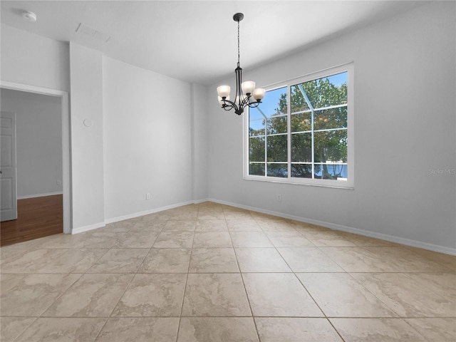 tiled spare room with a chandelier, a smoke detector, and baseboards