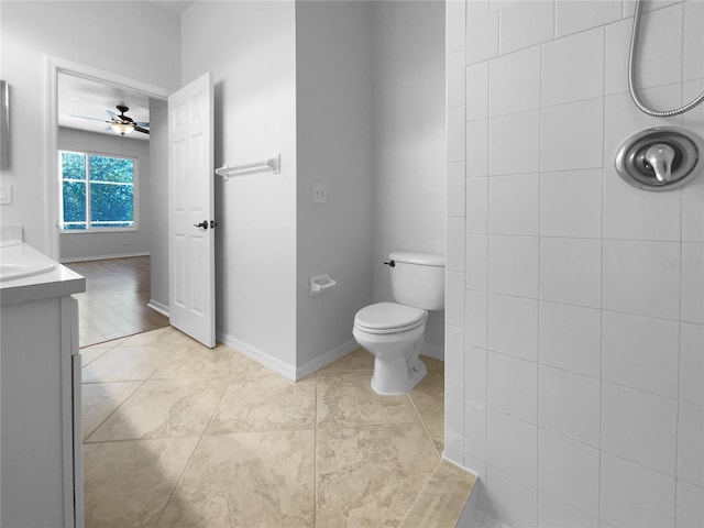 bathroom with ceiling fan, vanity, toilet, baseboards, and tile patterned flooring