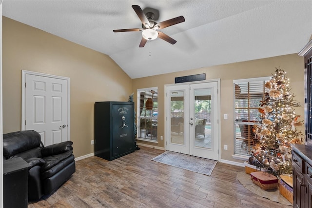 interior space featuring ceiling fan, baseboards, and wood finished floors