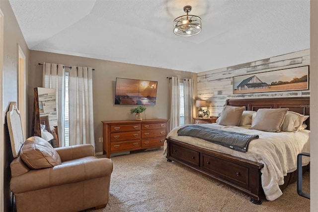 bedroom featuring vaulted ceiling, light carpet, and wood walls