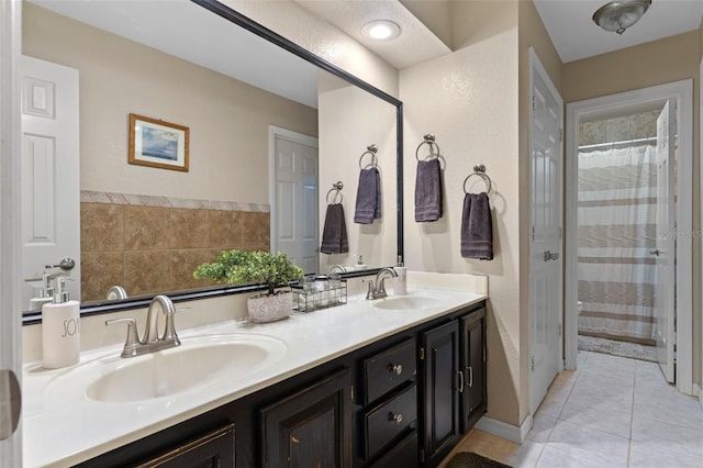 full bath with tile patterned floors, double vanity, a sink, and curtained shower