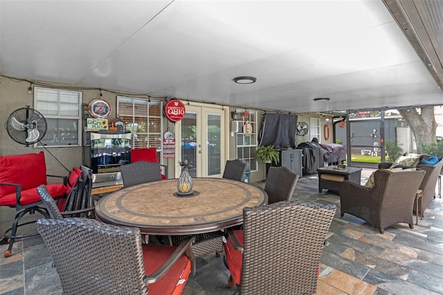 view of patio with an outdoor living space, outdoor dining space, and french doors