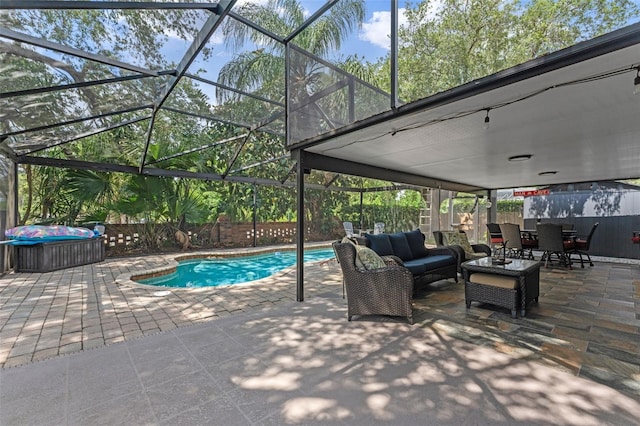 view of pool with a patio area, a fenced backyard, a fenced in pool, and glass enclosure