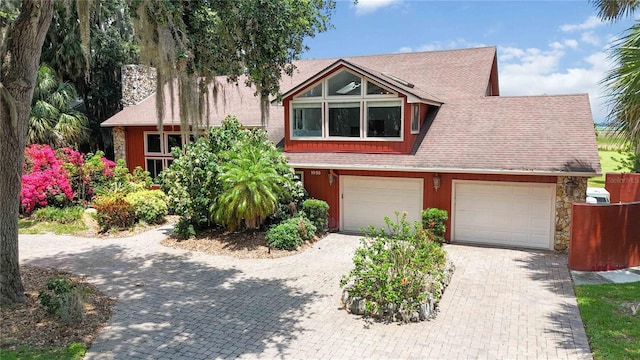 1093 Hidden Harbor Ln, Kissimmee, FL 34746 - view of front of property featuring driveway, a shingled roof, and an attached garage