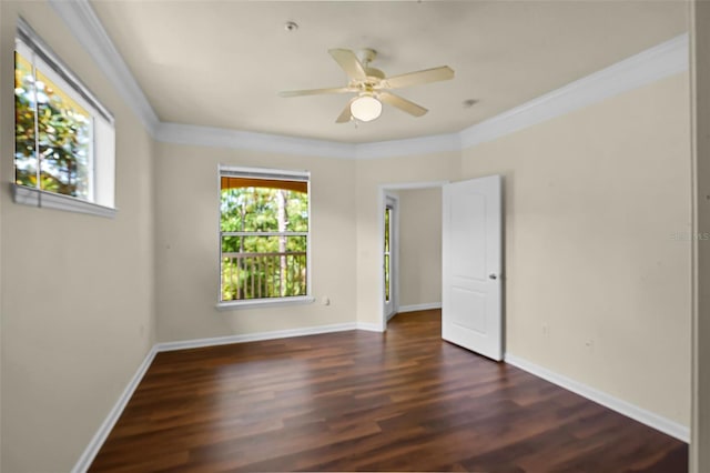 spare room featuring ceiling fan, ornamental molding, baseboards, and wood finished floors