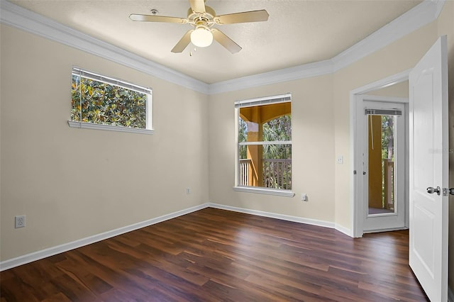 spare room with a wealth of natural light, ornamental molding, and dark wood-style floors