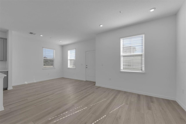 305 Platform Ln, Debary, FL 32713 - unfurnished living room with light wood finished floors, baseboards, visible vents, and recessed lighting