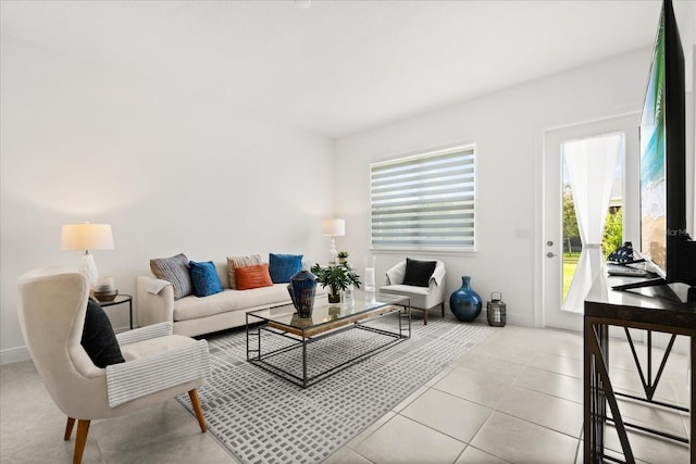 2524 Datura Loop, Saint Cloud, FL 34772 - living room featuring plenty of natural light, light tile patterned flooring, and baseboards
