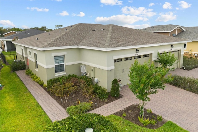 2524 Datura Loop, Saint Cloud, FL 34772 - view of side of home featuring roof with shingles, an attached garage, stucco siding, and decorative driveway