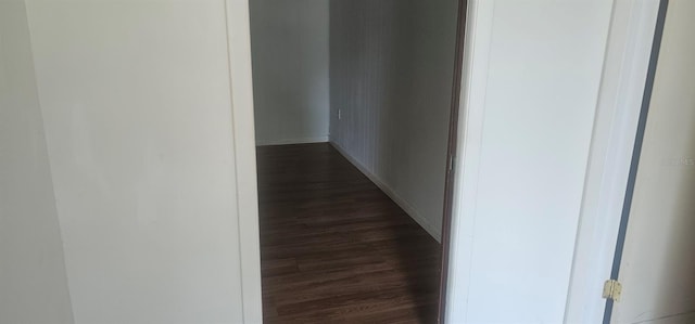 hall with baseboards and dark wood-style floors
