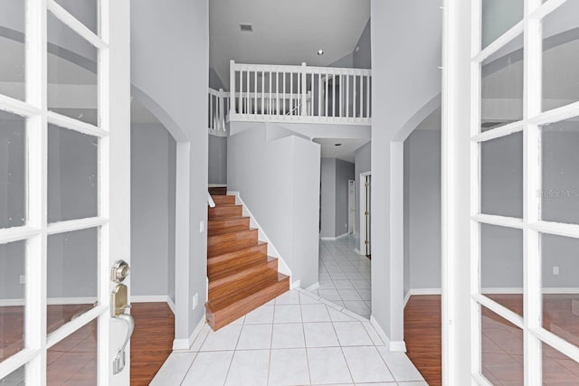 1802 Imperial Palm Dr, Apopka, FL 32712 - entryway featuring arched walkways, a towering ceiling, tile patterned floors, french doors, and stairs