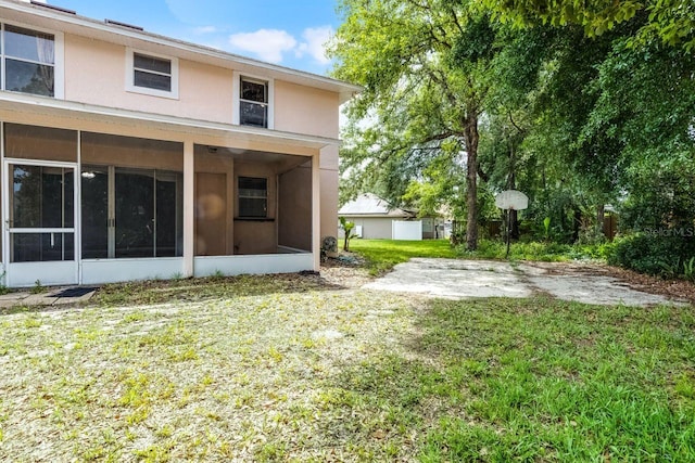 1802 Imperial Palm Dr, Apopka, FL 32712 - rear view of house featuring a sunroom, a yard, and stucco siding