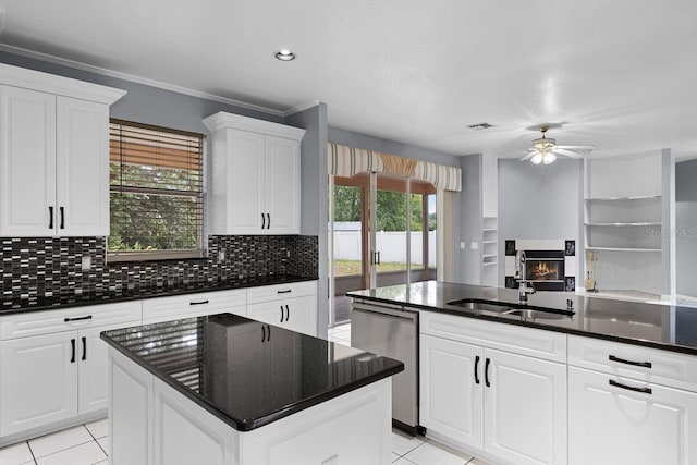 1802 Imperial Palm Dr, Apopka, FL 32712 - kitchen featuring a sink, a glass covered fireplace, dishwasher, ceiling fan, and light tile patterned floors