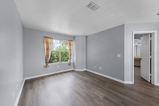 1802 Imperial Palm Dr, Apopka, FL 32712 - unfurnished room featuring a textured ceiling, dark wood-style flooring, and baseboards
