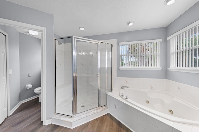 1802 Imperial Palm Dr, Apopka, FL 32712 - full bath with a shower stall, a jetted tub, wood finished floors, toilet, and recessed lighting