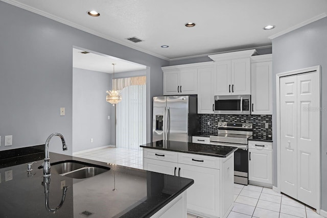 1802 Imperial Palm Dr, Apopka, FL 32712 - kitchen featuring stainless steel appliances, a sink, ornamental molding, backsplash, and white cabinetry