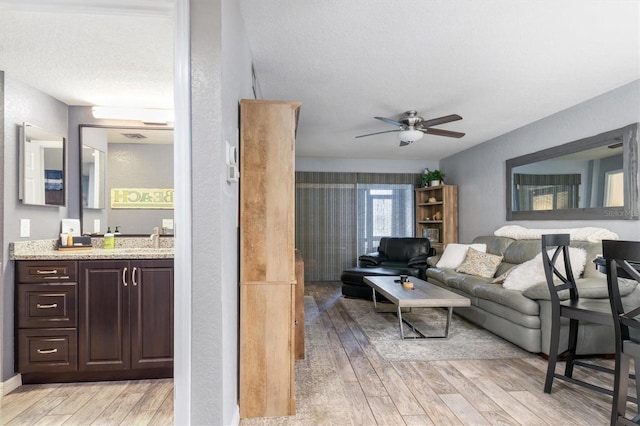 3221 White Ibis Ct Unit C1, Punta Gorda, FL 33950 - living area featuring light wood-type flooring, a ceiling fan, and a textured ceiling