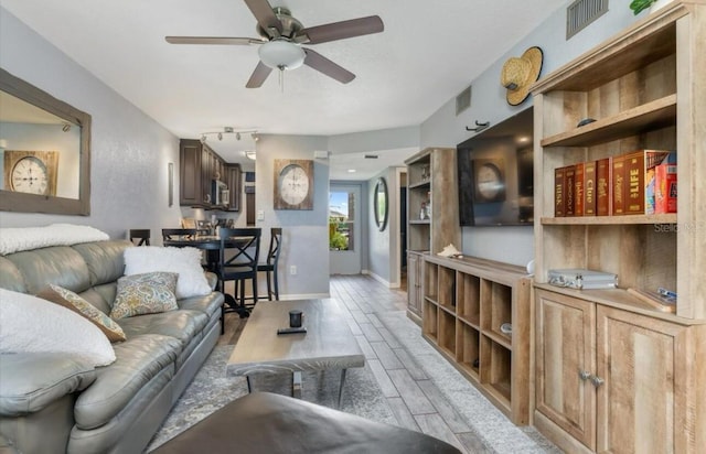 3221 White Ibis Ct Unit C1, Punta Gorda, FL 33950 - living area with a ceiling fan, light wood finished floors, and baseboards