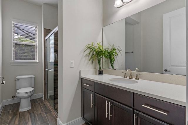 10819 Savona Way, Orlando, FL 32827 - bathroom with toilet, a stall shower, vanity, and baseboards
