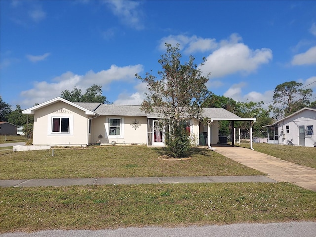 4299 Bullard St, North Port, FL 34287 - single story home with a front lawn, concrete driveway, stucco siding, and an attached carport