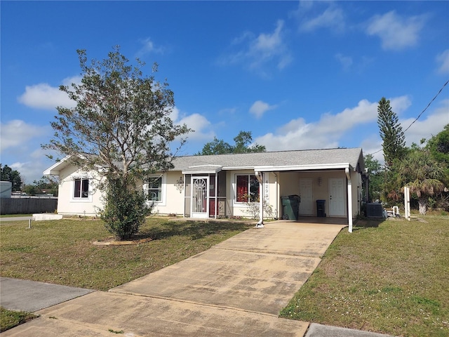 4299 Bullard St, North Port, FL 34287 - single story home featuring central air condition unit, concrete driveway, a front lawn, and a carport