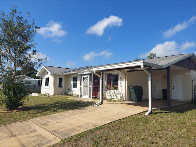 4299 Bullard St, North Port, FL 34287 - ranch-style home with stucco siding, a carport, and concrete driveway