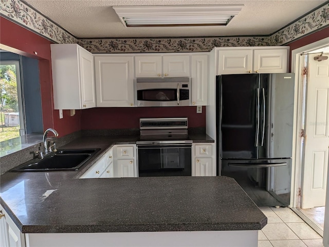 4299 Bullard St, North Port, FL 34287 - kitchen featuring black appliances, a sink, white cabinets, dark countertops, and a textured ceiling