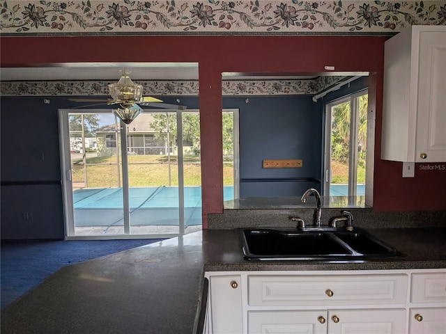 4299 Bullard St, North Port, FL 34287 - kitchen with a sink, dark countertops, and plenty of natural light