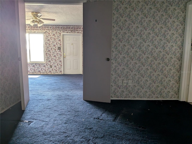 4299 Bullard St, North Port, FL 34287 - carpeted spare room with wallpapered walls, a ceiling fan, and a textured ceiling
