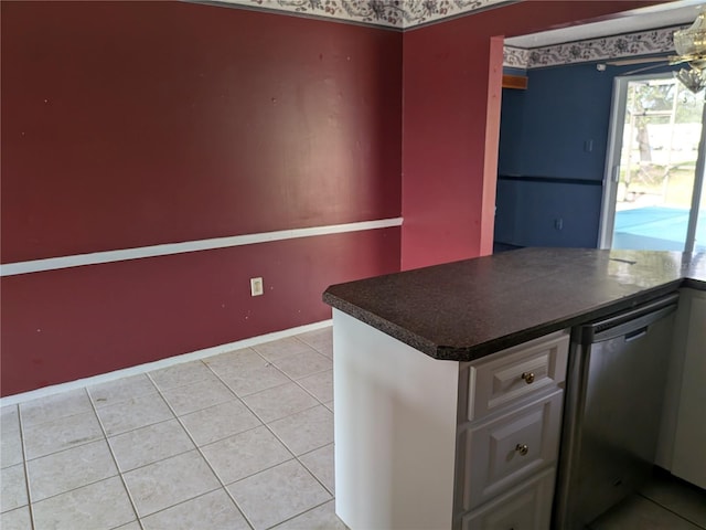 4299 Bullard St, North Port, FL 34287 - kitchen with dark countertops, stainless steel dishwasher, light tile patterned flooring, and baseboards