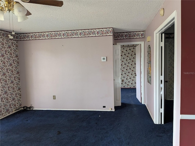 4299 Bullard St, North Port, FL 34287 - spare room featuring wallpapered walls, a textured ceiling, carpet flooring, ceiling fan, and a smoke detector