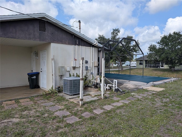 4299 Bullard St, North Port, FL 34287 - view of grassy yard featuring central AC, a patio area, and a lanai