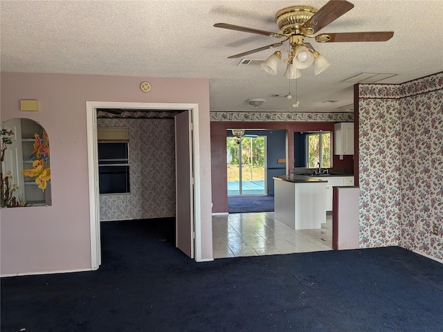 4299 Bullard St, North Port, FL 34287 - unfurnished living room with wallpapered walls, a textured ceiling, a sink, ceiling fan, and light colored carpet
