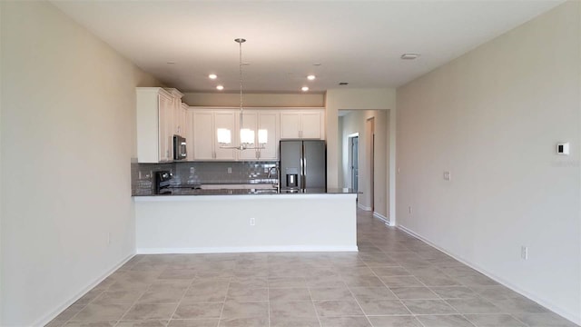 kitchen with fridge with ice dispenser, a peninsula, stainless steel range with electric stovetop, decorative backsplash, and recessed lighting